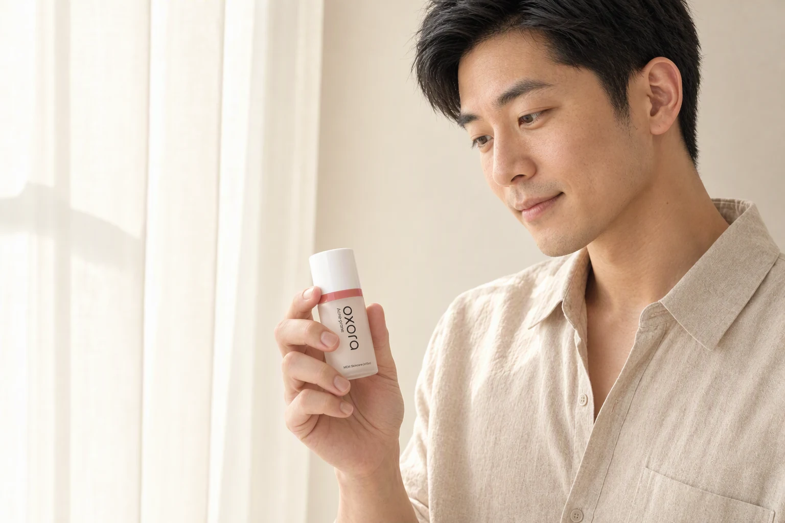 A man holding Oxora Acne-prone by a sunlit window